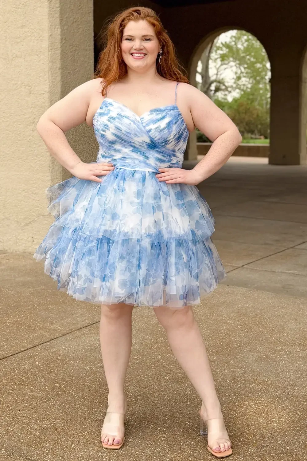 model is wearing a light blue short plus size homecoming dress